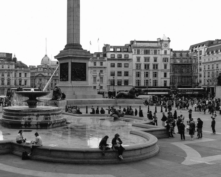 people are in the city next to a fountain