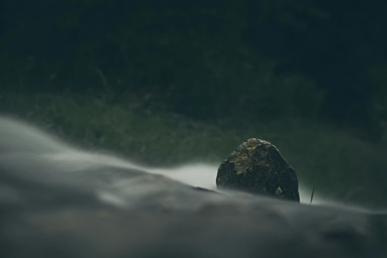 a large rock is in the middle of water