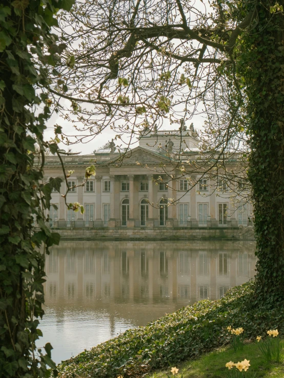 a large white building sitting above a body of water