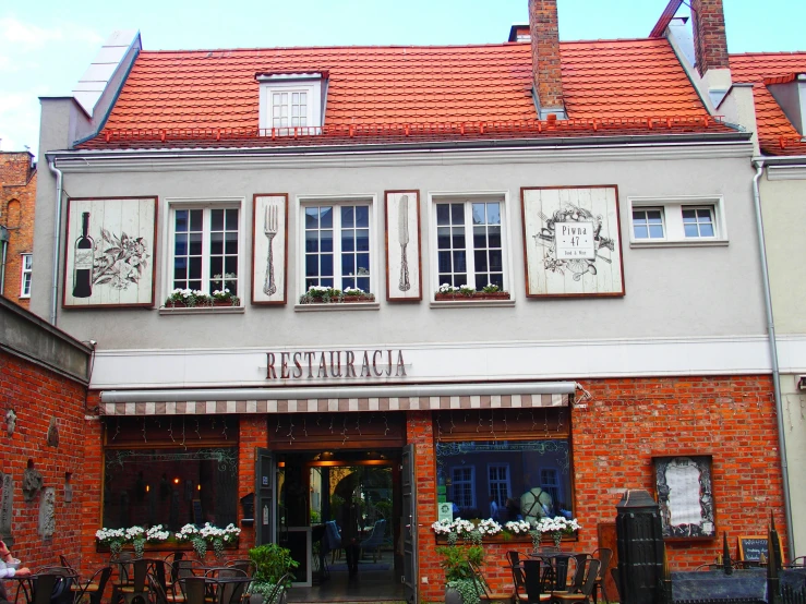 an outside view of a restaurant with tables and chairs