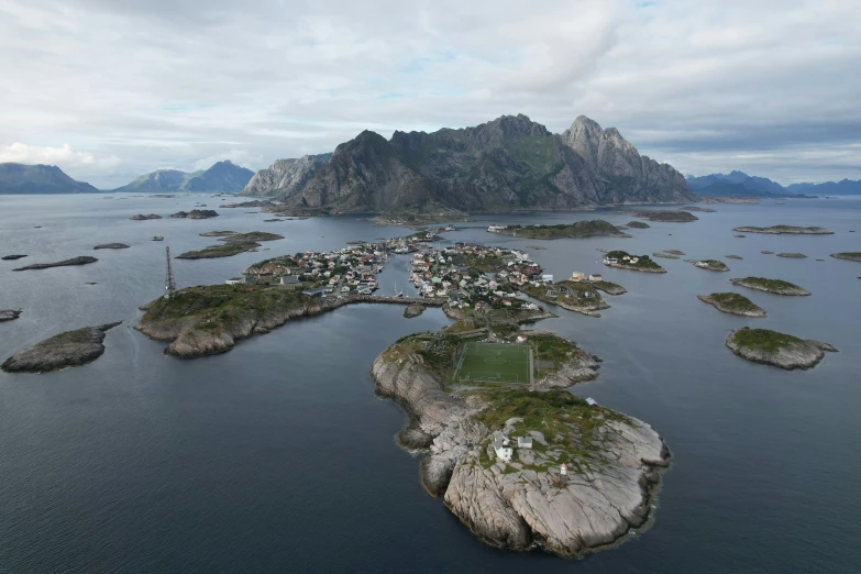 a village is surrounded by large mountains in the ocean