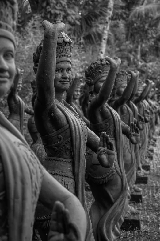 a group of asian statues are shown in black and white