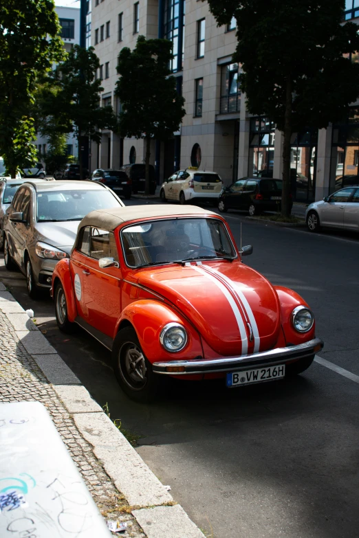 a car parked at the curb next to a building