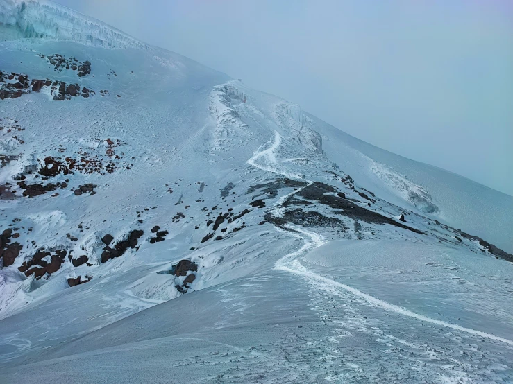 the skier is skiing down the mountain on the snow