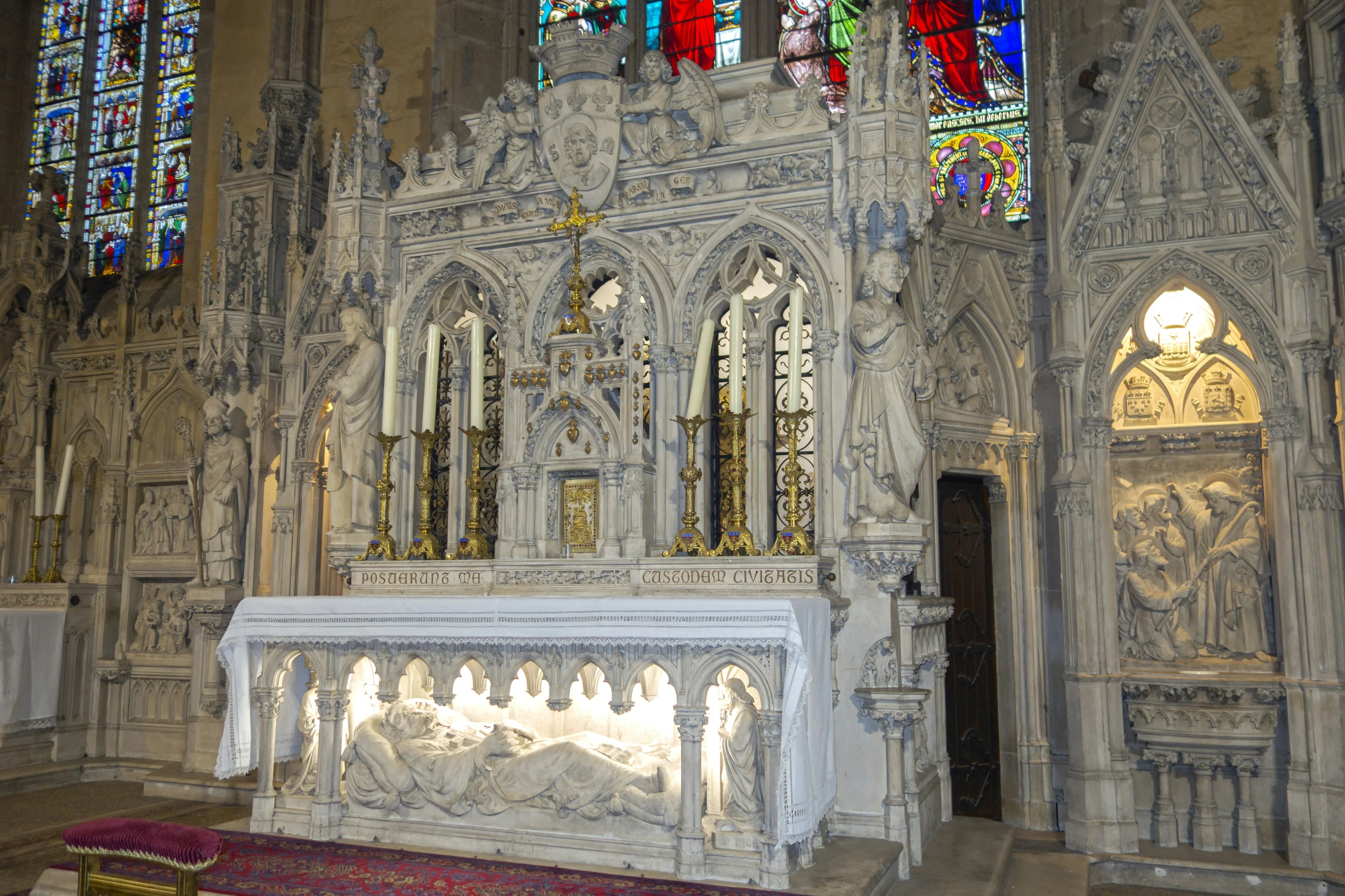 the interior of a church with very old carvings and stained glass