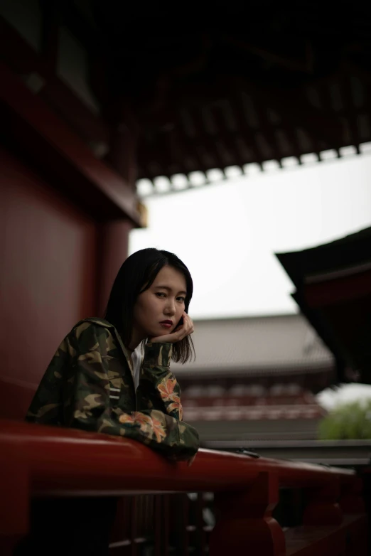 a woman sitting with her hand on her head