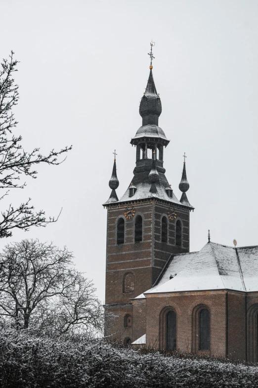 a church with three steeples and a snow covered top