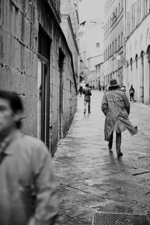 man walking along the road with his coat on