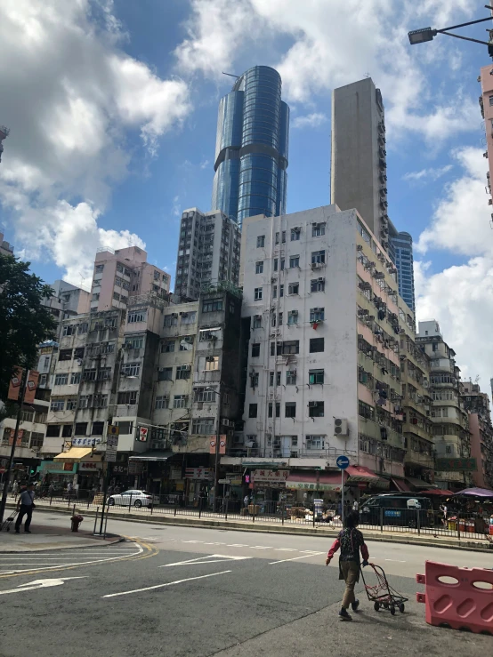 a cityscape of tall buildings with pedestrians and bicyclist