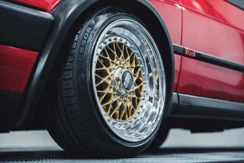 a close up view of the rim on a red car