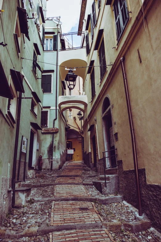 a narrow alleyway with brick and stone steps