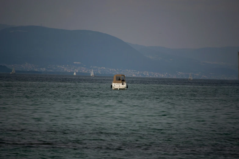 a boat is sitting in the middle of the ocean