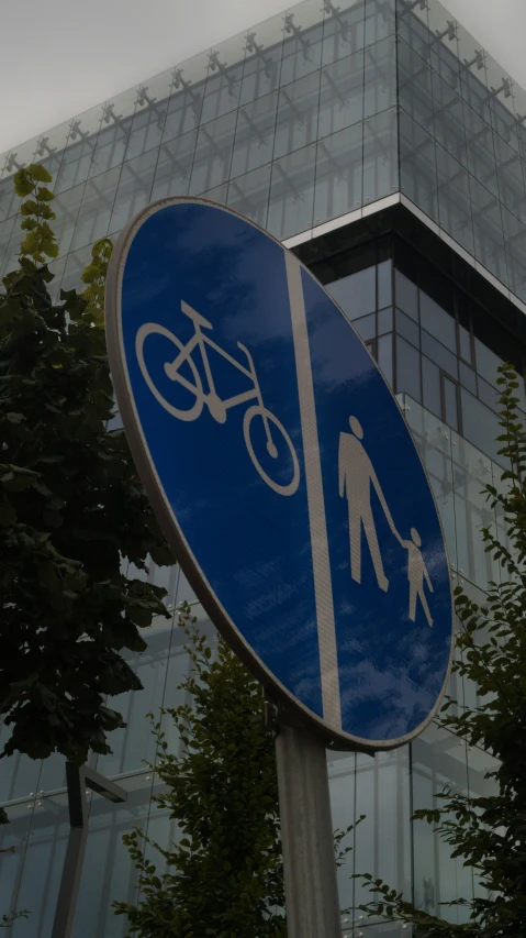 a blue sign with an image of people walking and cycling on it