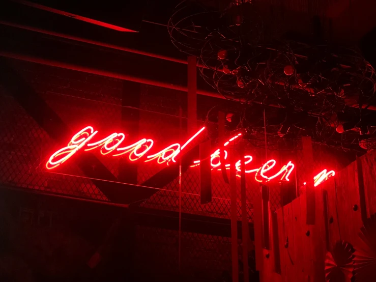 a neon sign that reads good viber hanging from the side