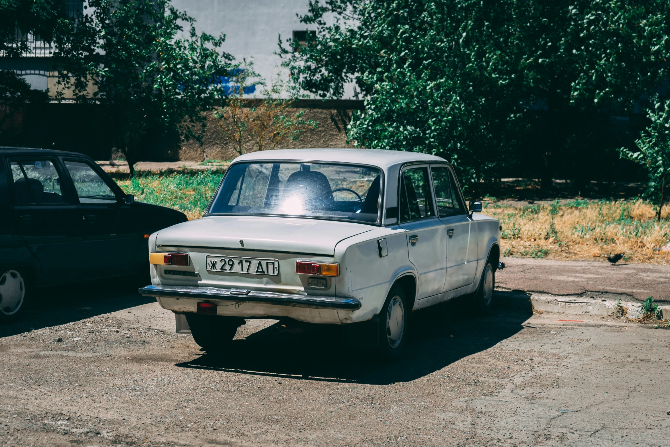 a vintage car sitting on top of a parking lot