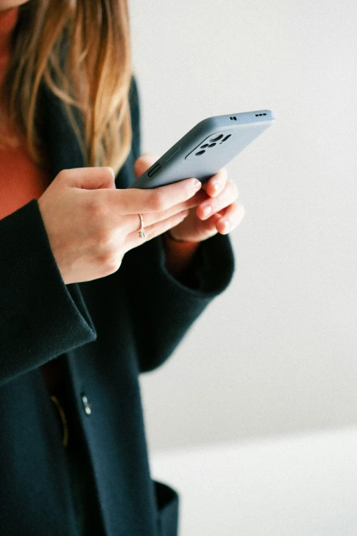 a woman using her smartphone while holding it