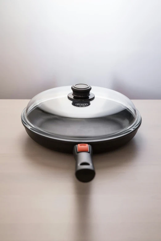 a cooking pan and an object that is on the table