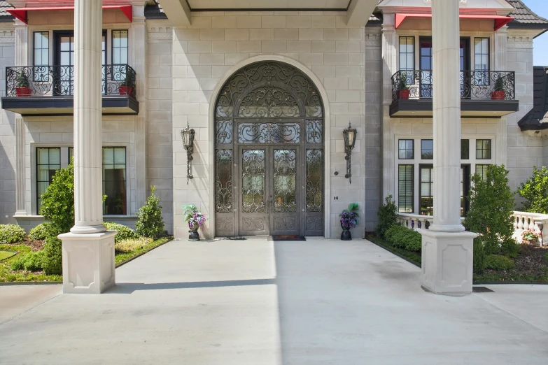 a big house with a porch and covered walkway