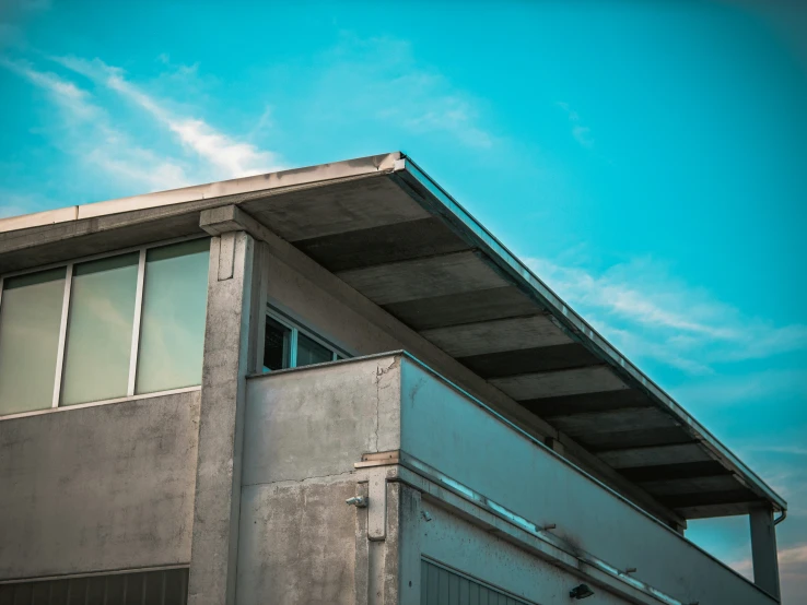 a bird is perched on the roof of a building