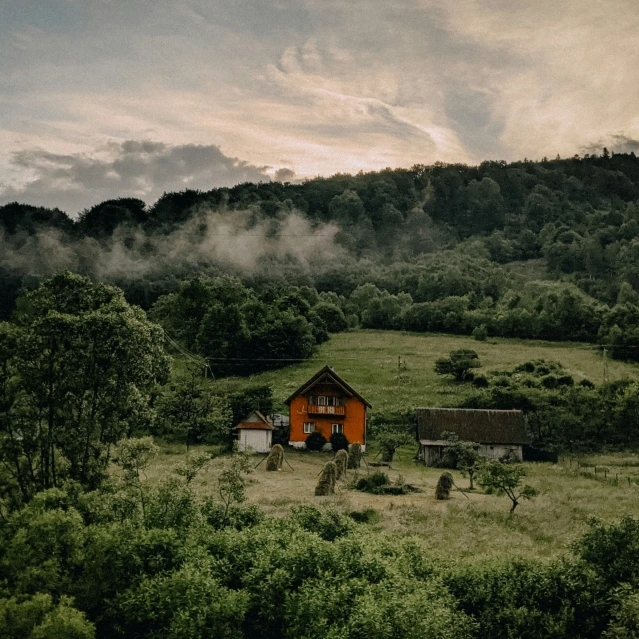 the red house is on the green hillside