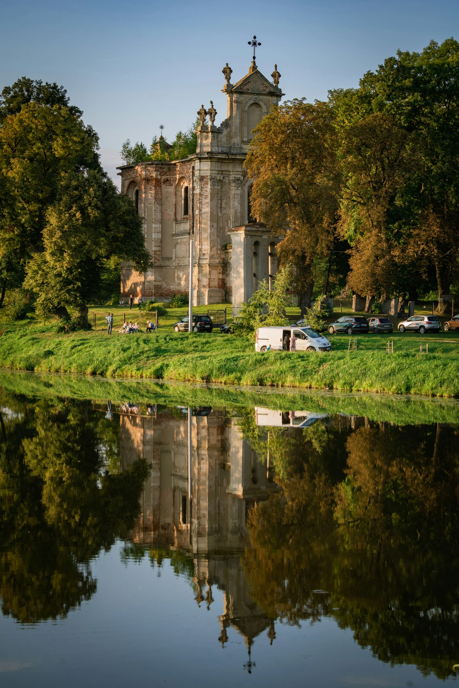 a castle is pictured with trees and green grass surrounding