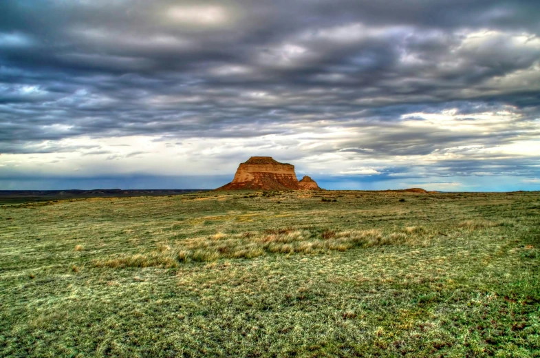 a very tall, rocky mountain in the middle of nowhere