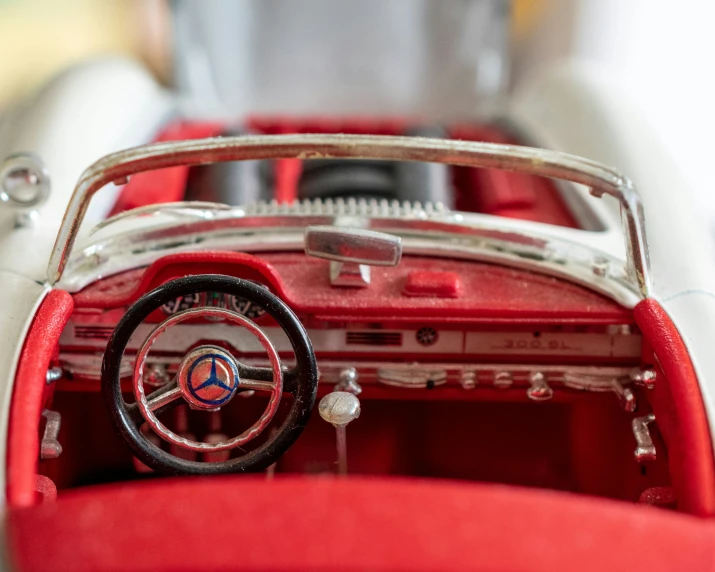 the dashboard of a car with red and white paint