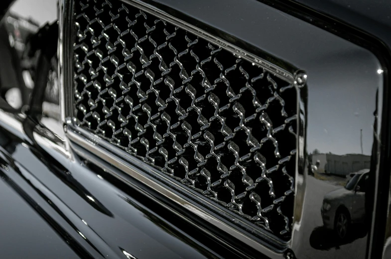 a car emblem is showing that the grille has diamond shapes