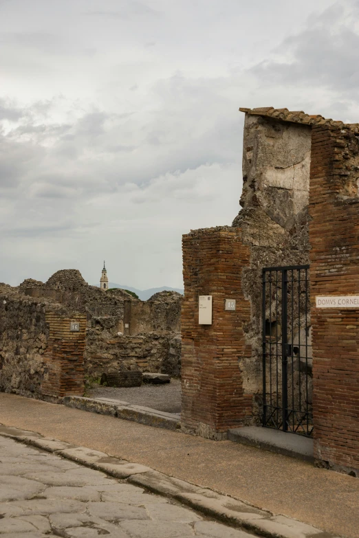 a brick building with a doorway and gate