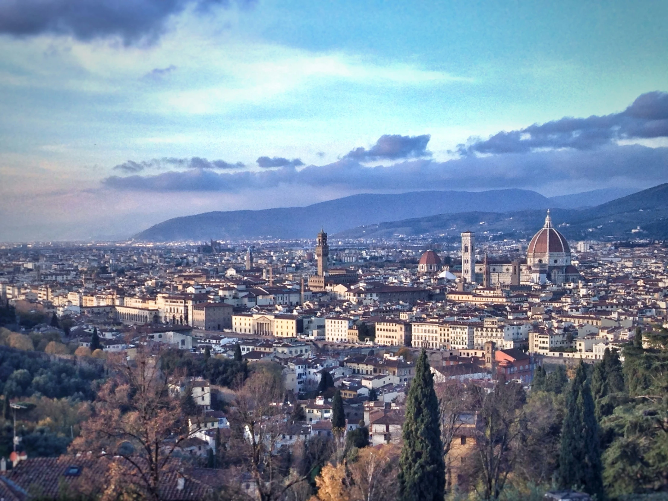 a city sits above a hillside on the hills