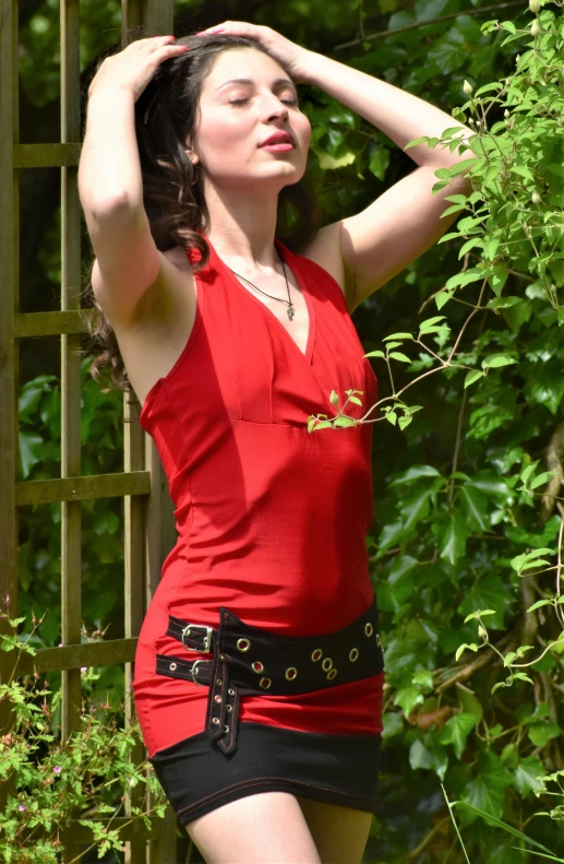 a woman in a red top and black skirt