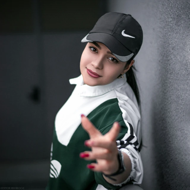 the  is posing for a picture wearing a nike hat