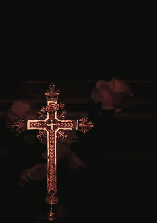 a glowing cross sitting in the dark with smoke