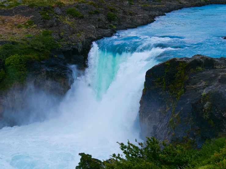 a waterfall has water casing and trees