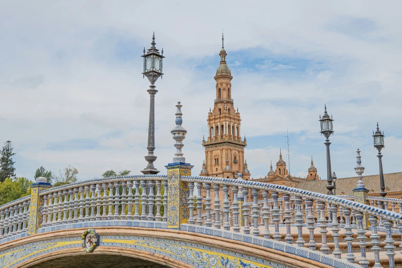 a decorative bridge with the building in the background