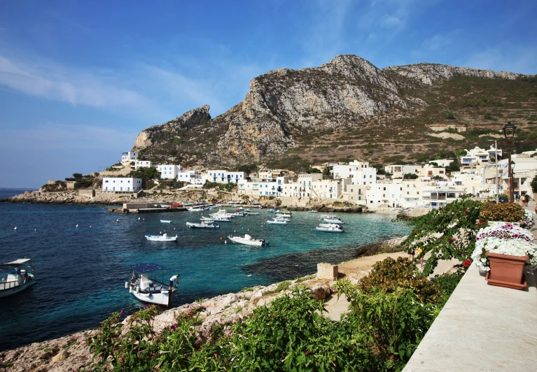 boats moored and docked at the shoreline of an island