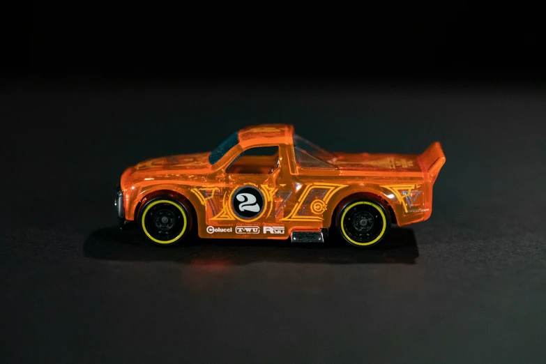 a toy car on a black table with a glowing background