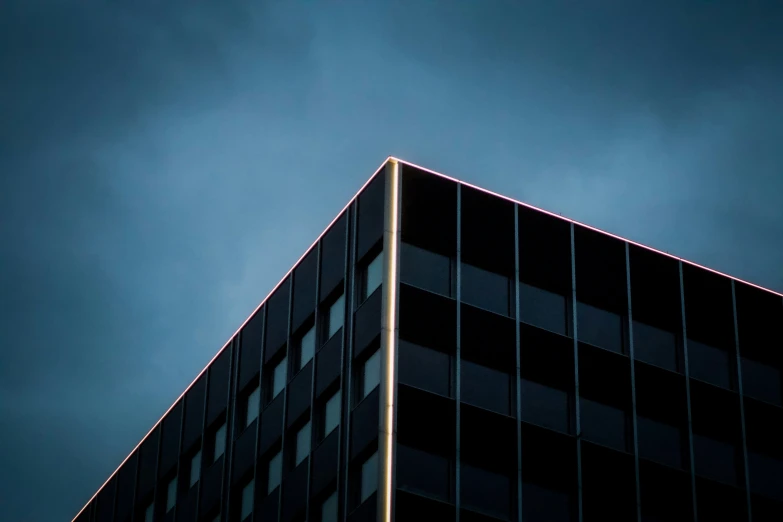 a jet flying over an upward dark building