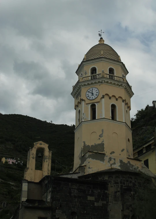 a clock tower in an old town with crumbling windows