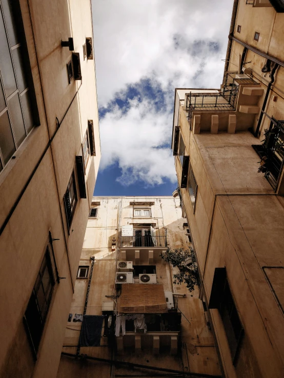 an upward view of two buildings from the ground