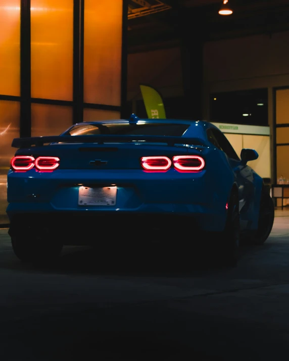 a blue car is parked on a street