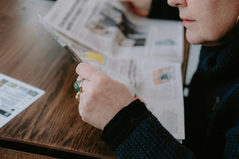 a lady looking at the news while reading her phone