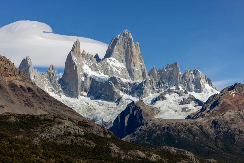 the tops of snowy mountain peaks are covered in snow