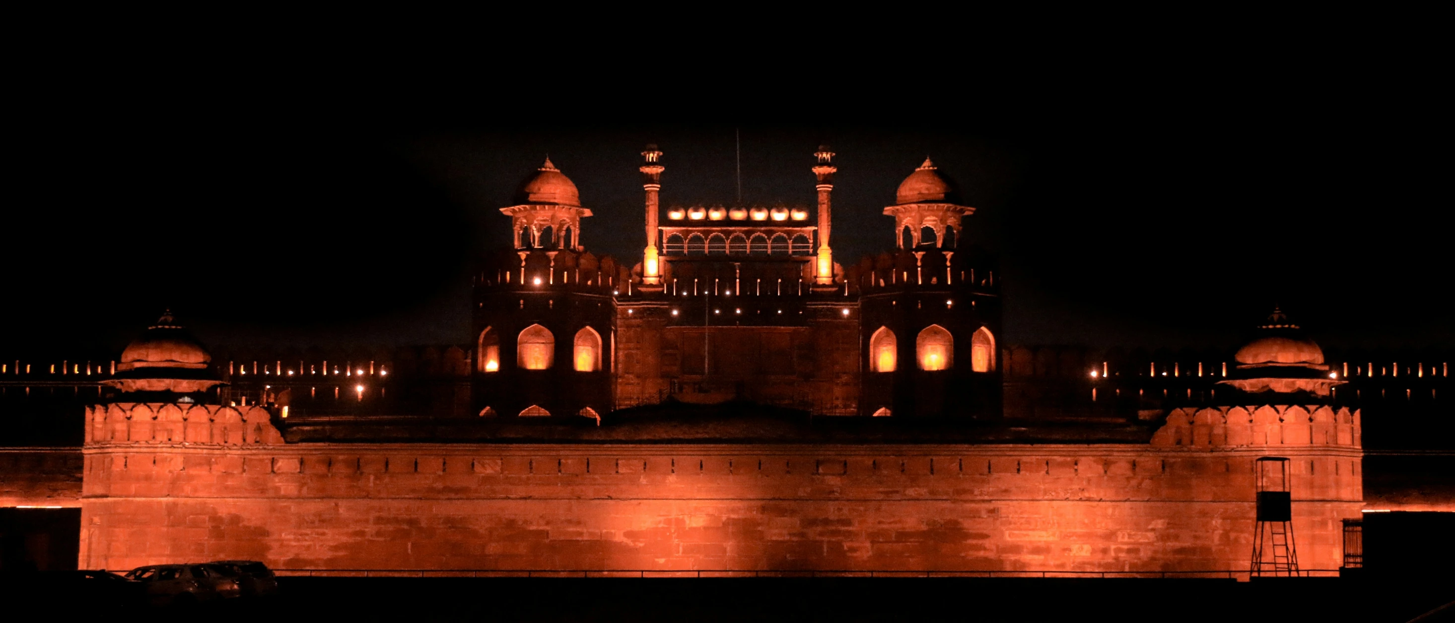 a castle with towers lit up at night