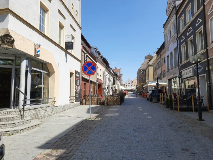 small town street with people sitting at the sidewalk