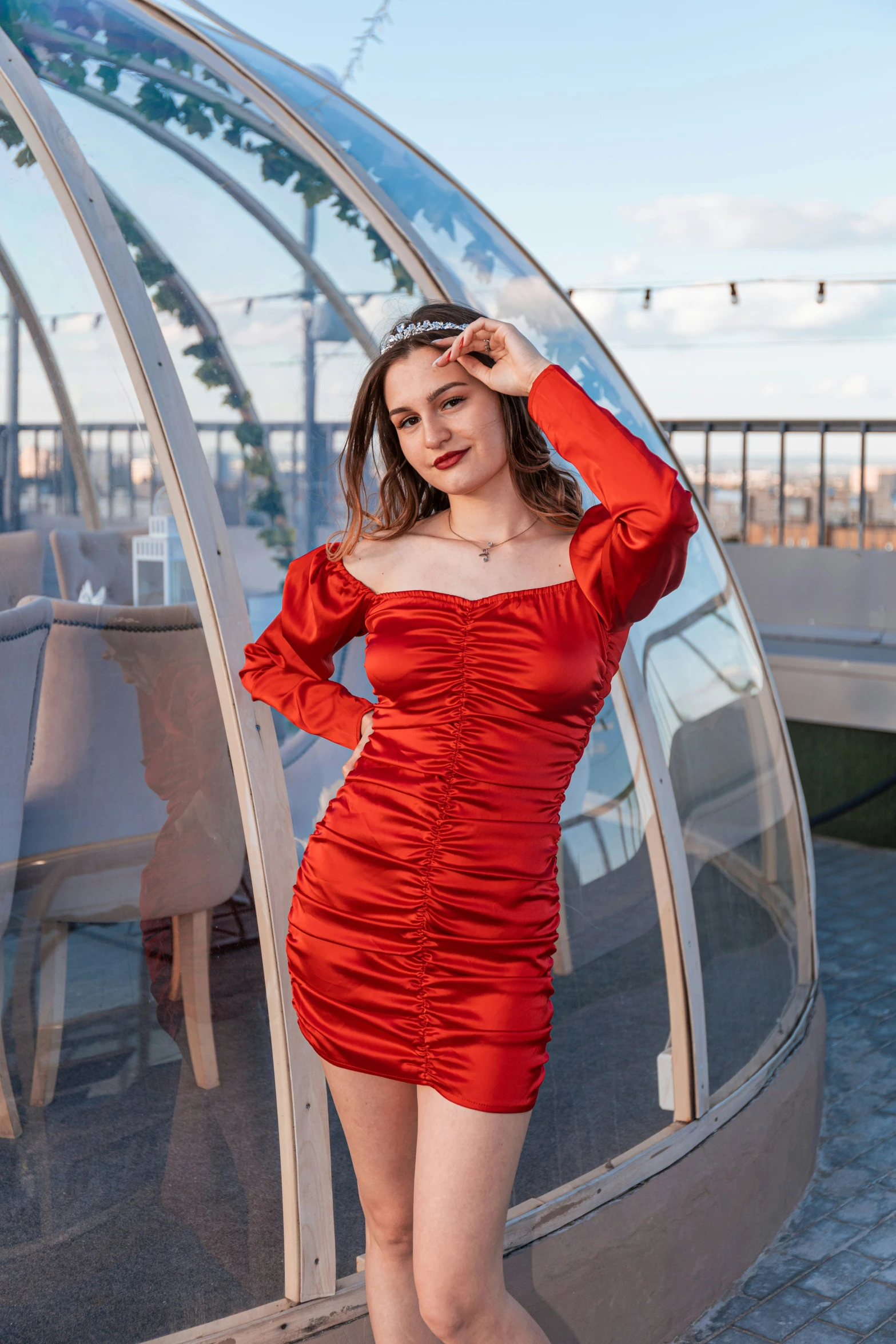 a woman in a short red dress poses for the camera