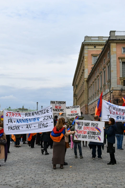 a group of people holding signs and signs