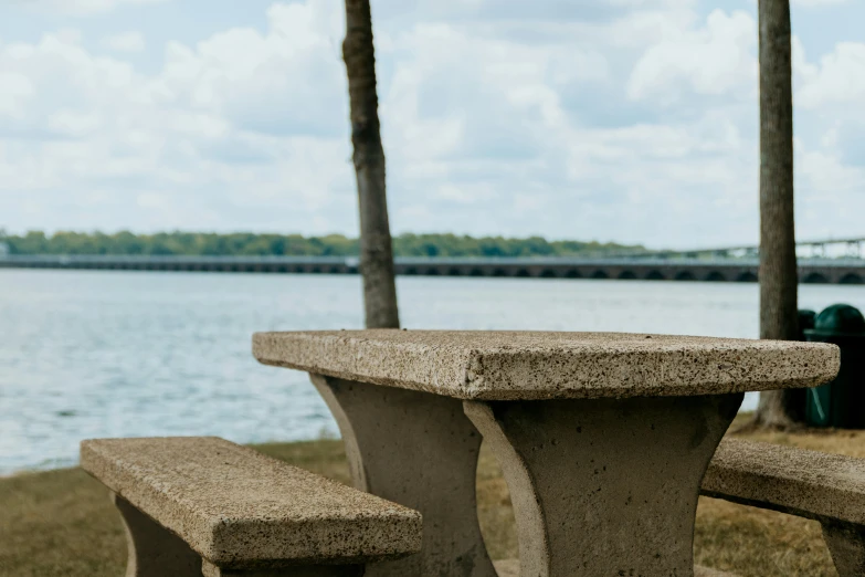 concrete bench at a public park overlooking water