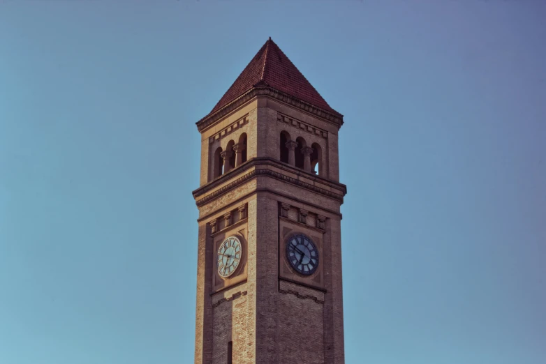 clock tower with light beige and dark brown granite