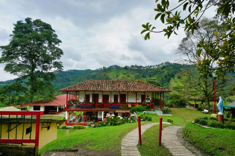 a home with a grassy yard in front of a mountain